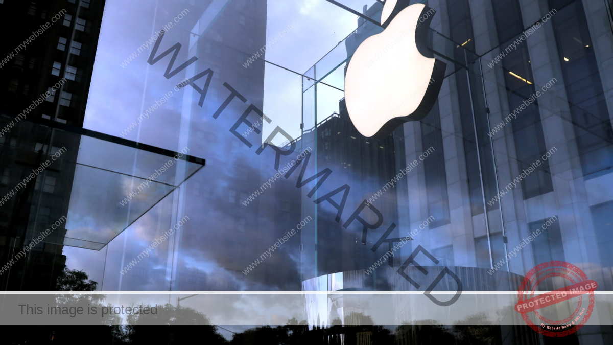 FILE PHOTO: The Apple Inc. logo is seen hanging at the entrance to the Apple store on 5th Avenue in Manhattan, New York, U.S., October 16, 2019. REUTERS/Mike Segar