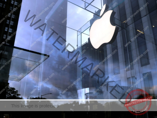 FILE PHOTO: The Apple Inc. logo is seen hanging at the entrance to the Apple store on 5th Avenue in Manhattan, New York, U.S., October 16, 2019. REUTERS/Mike Segar